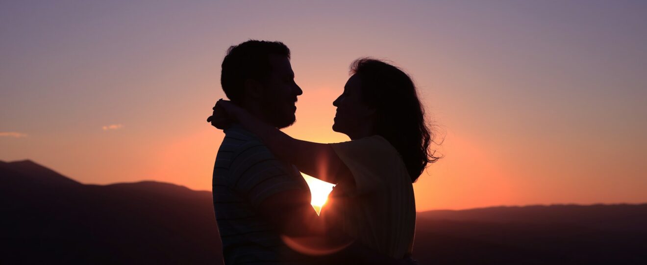 silhouette of hugging couple