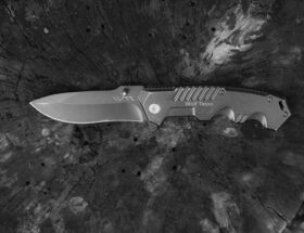 black handled knife on black and white surface