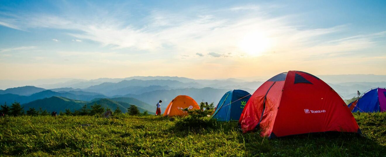 Photo of Pitched Dome Tents Overlooking Mountain Ranges