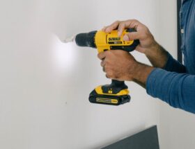 person holding yellow and black cordless hand drill