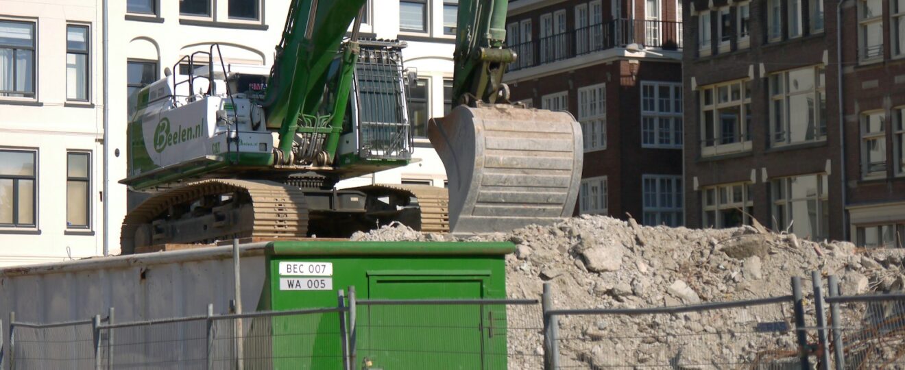 a construction site with a green dump truck