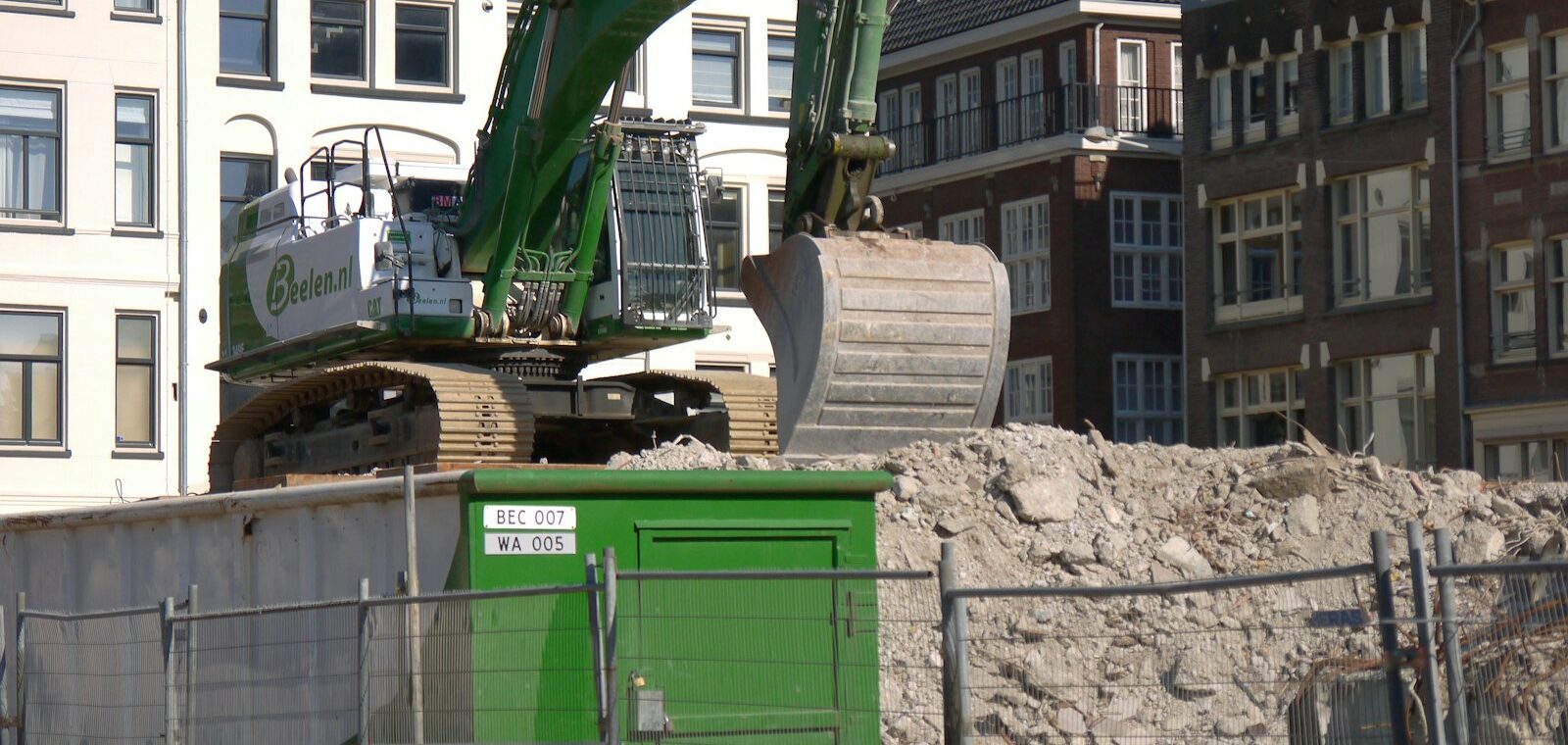 a construction site with a green dump truck