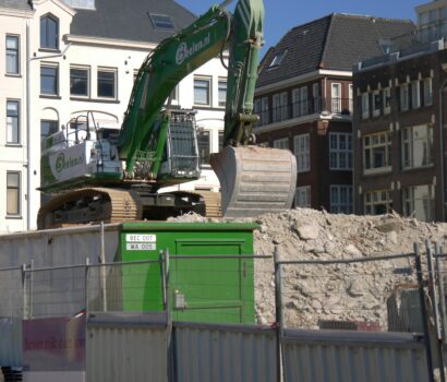 a construction site with a green dump truck