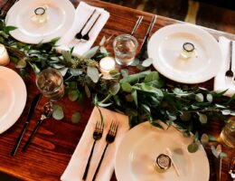 white ceramic dinner plate set on brown wooden table