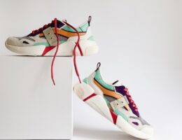 pair of white-and-orange athletic shoes on white box