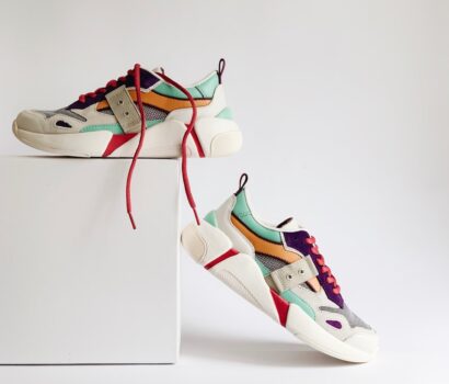 pair of white-and-orange athletic shoes on white box
